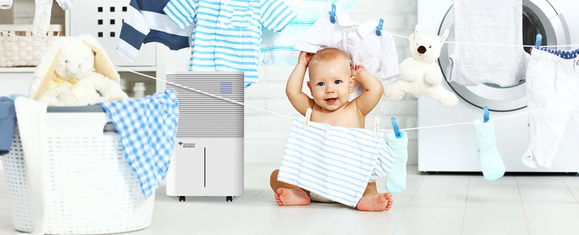 Child interacting with MyCond  Roomer Hepa 25 dehumidifier in a bathroom setting.